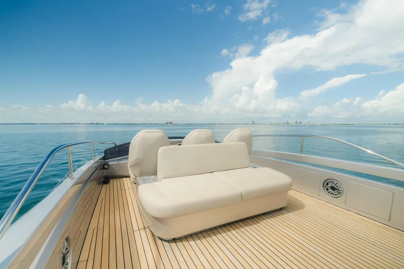 Slide: The Image of Luxurious 2021 Pershing 8X yacht deck with seating, overlooking calm ocean and clear sky. - 29