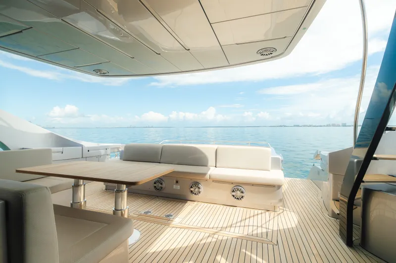 Slide: The Image of Luxurious 2021 Pershing 8X yacht deck with seating, table, and ocean view. - 5