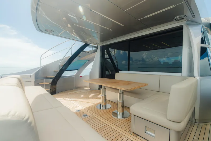 Slide: The Image of Luxurious 2021 Pershing 8X yacht deck with elegant seating and wooden table. - 7