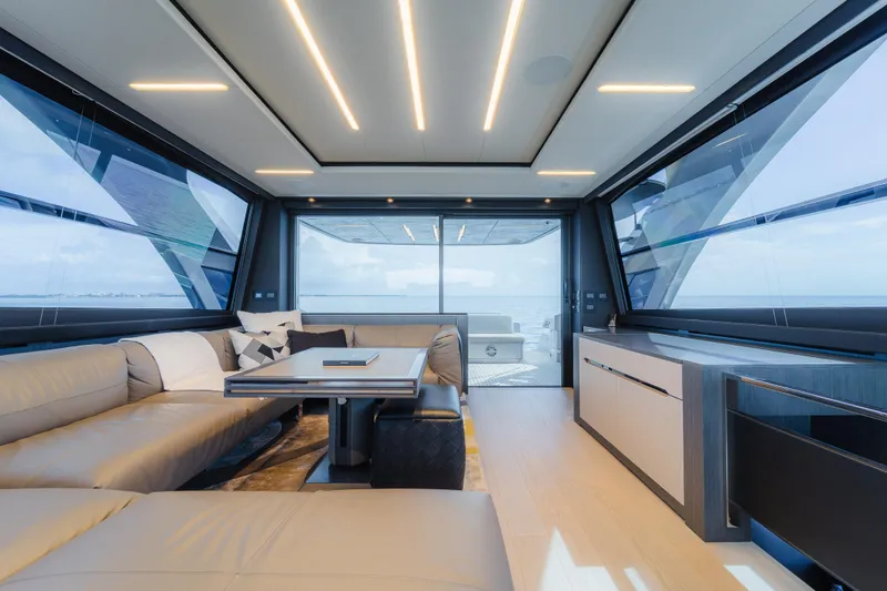 Slide: The Image of Luxurious interior of 2021 Pershing 8X yacht with modern seating and panoramic windows. - 8