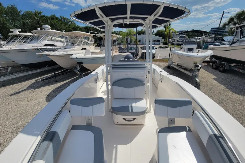 Slide: The Image of 2021 Robalo R200 Center Console boat with seating, parked among other boats. - 13