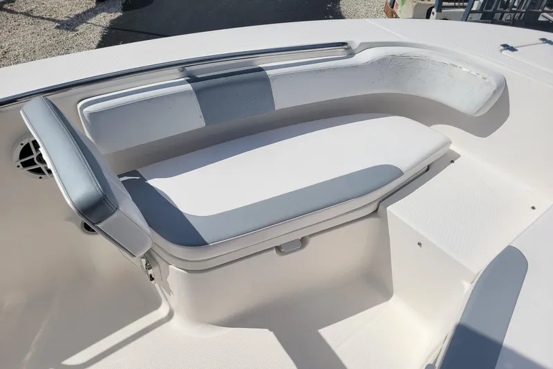 Slide: The Image of 2021 Robalo R200 Center Console boat seating area with cushioned bench and speaker. - 14