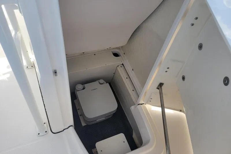 Slide: The Image of 2021 Robalo R200 Center Console boat interior storage compartment with portable toilet. - 17