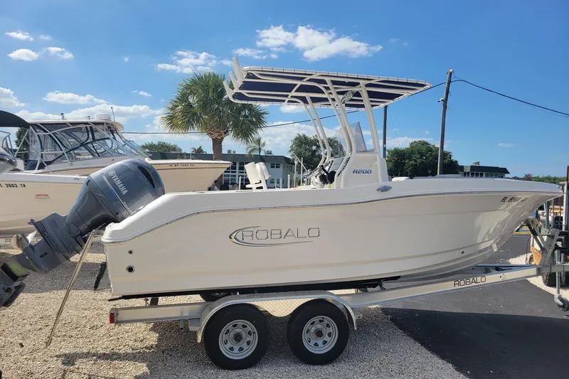 Slide: The Image of 2021 Robalo R200 Center Console boat on trailer, featuring Yamaha outboard motor. - 5
