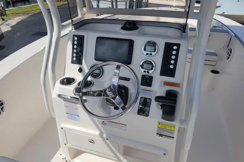 Slide: The Image of 2021 Robalo R200 Center Console boat dashboard with steering wheel and controls. - 6