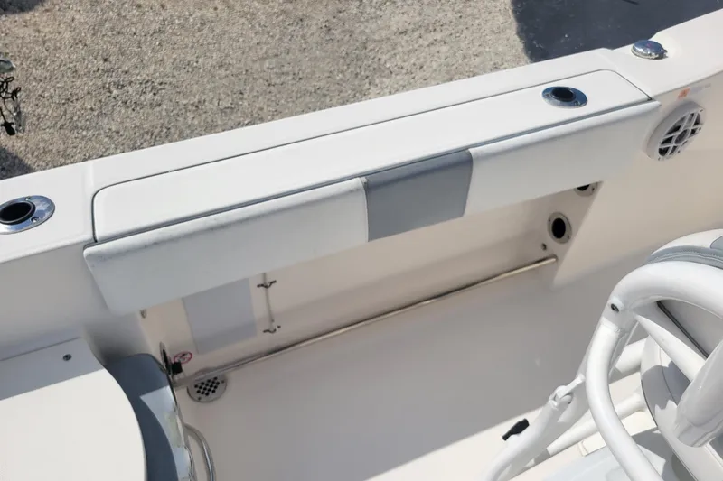Slide: The Image of 2021 Robalo R200 Center Console boat interior with seating and rod holders. - 9