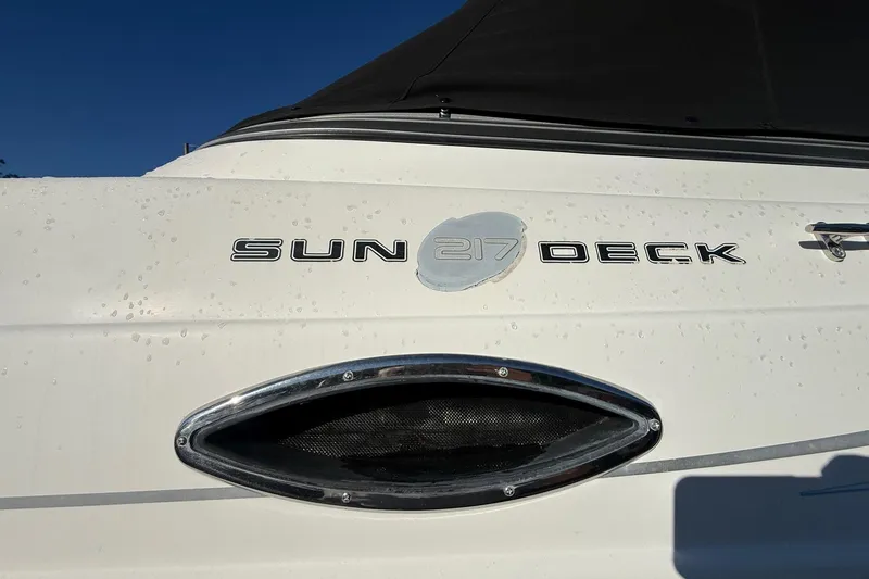Slide: The Image of 2011 Hurricane SunDeck 217 OB boat exterior with logo and sleek design details. - 2