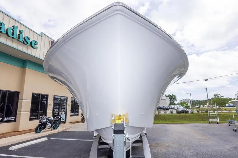Slide: The Image of Front view of a 2026 SeaHunter 33 Tournament boat parked outside a building. - 10