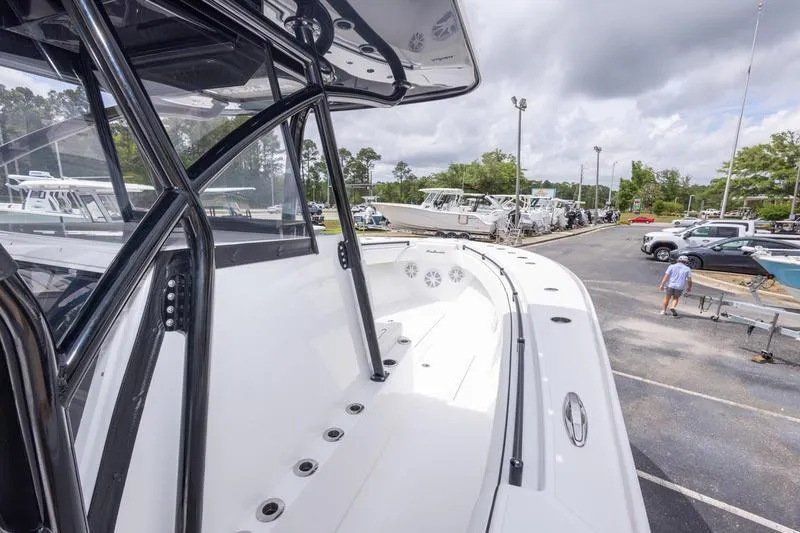 Slide: The Image of 2026 SeaHunter 33 Tournament boat on display in a marina parking lot. - 11