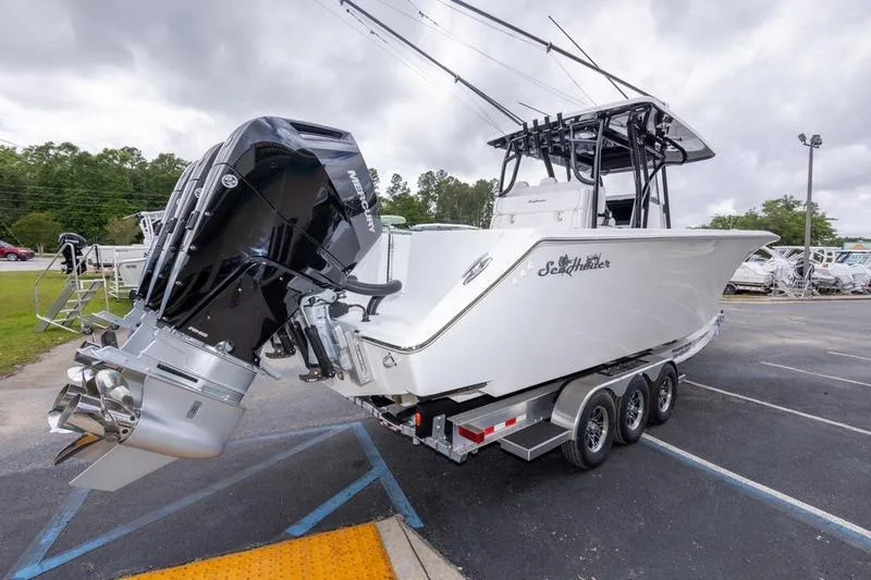 Slide: The Image of 2026 SeaHunter 33 Tournament boat on trailer, featuring powerful outboard engines. - 17