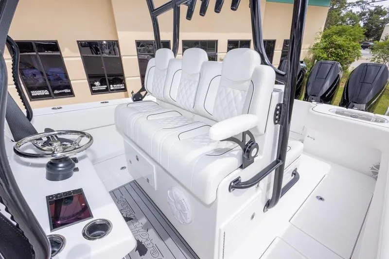 Slide: The Image of 2026 SeaHunter 33 Tournament boat interior with white seating and modern steering console. - 19