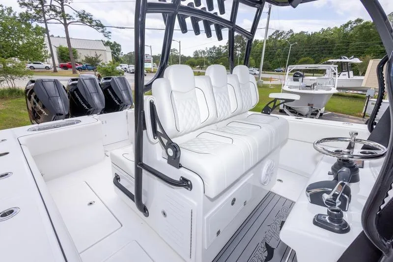 Slide: The Image of 2026 SeaHunter 33 Tournament boat interior with white seating and multiple outboard engines. - 20
