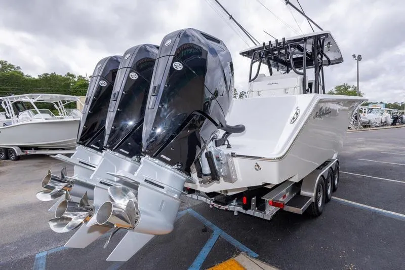 Slide: The Image of 2026 SeaHunter 33 Tournament boat with triple outboard engines on a trailer. - 25