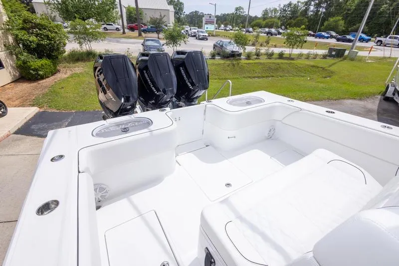 Slide: The Image of 2026 SeaHunter 33 Tournament boat with triple outboard engines, docked outdoors. - 28