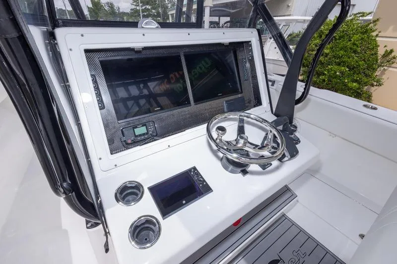 Slide: The Image of 2026 SeaHunter 33 Tournament boat dashboard with steering wheel and electronic displays. - 29