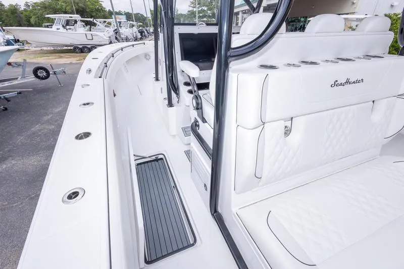 Slide: The Image of 2026 SeaHunter 33 Tournament boat interior with white seating and sleek design. - 31