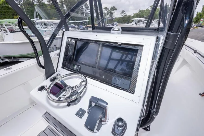 Slide: The Image of Helm of 2026 SeaHunter 33 Tournament boat with advanced navigation controls. - 33