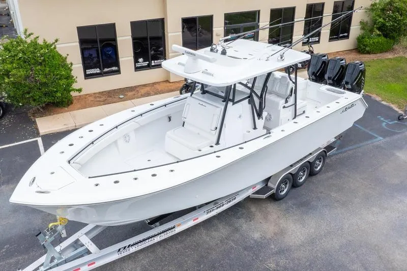Slide: The Image of 2026 SeaHunter 33 Tournament boat on trailer, parked outside a building. - 40