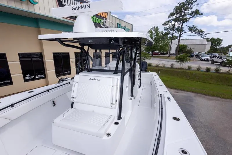 Slide: The Image of 2026 SeaHunter 33 Tournament boat with Garmin equipment, parked outdoors near a building. - 43