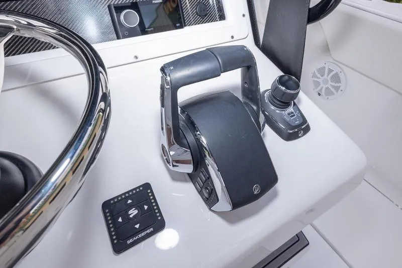 Slide: The Image of Control panel of 2026 SeaHunter 33 Tournament boat with steering wheel and throttle. - 44