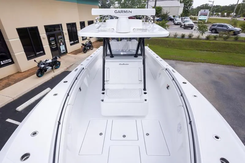 Slide: The Image of 2026 SeaHunter 33 Tournament boat with Garmin equipment, parked near a building and motorcycles. - 45