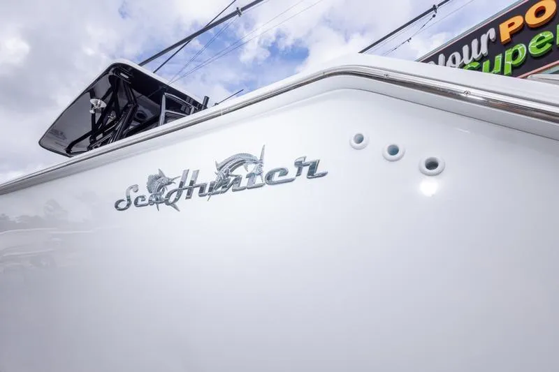 Slide: The Image of 2026 SeaHunter 33 Tournament boat with logo, viewed from the side under a cloudy sky. - 46
