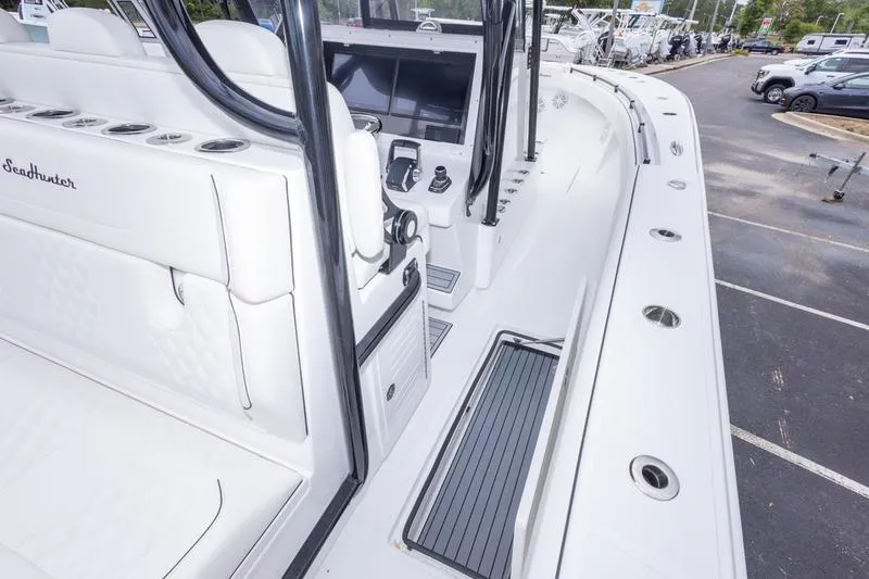 Slide: The Image of 2026 SeaHunter 33 Tournament boat interior with sleek white seating and modern controls. - 52