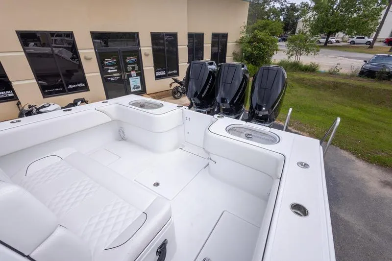 Slide: The Image of 2026 SeaHunter 33 Tournament boat with triple outboard engines, white seating, and spacious deck. - 7