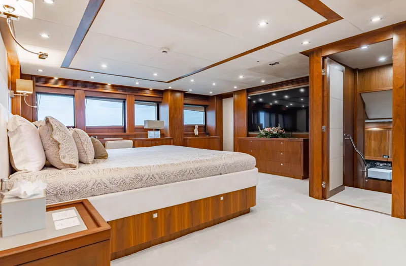 Slide: The Image of Luxurious master bedroom on a 2009 Sunseeker 121 yacht with elegant wood finishes. - 14