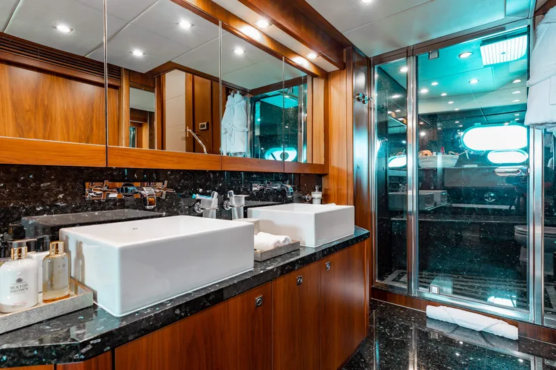 Slide: The Image of Luxurious bathroom in a 2009 Sunseeker 121 yacht with dual sinks and glass shower. - 15