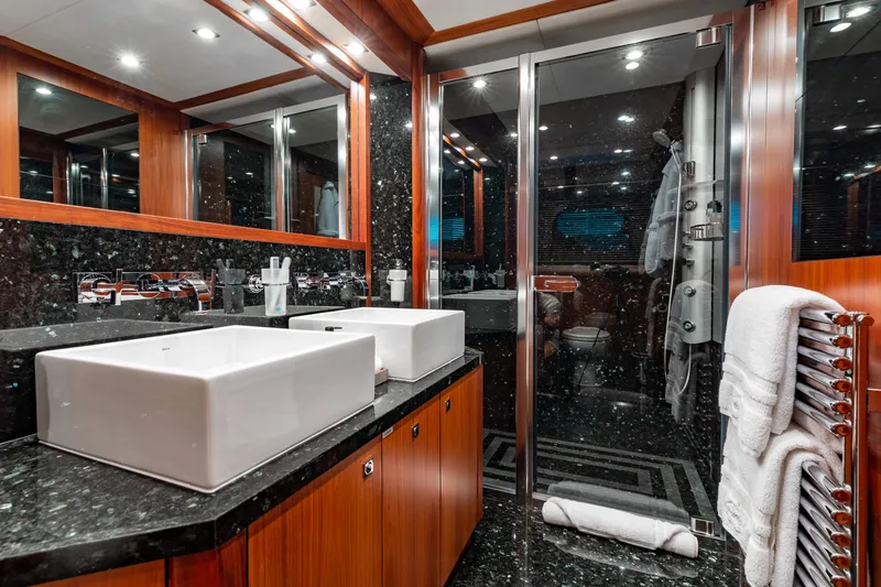 Slide: The Image of Luxurious bathroom on a 2009 Sunseeker 121 yacht with dual sinks and modern fixtures. - 24
