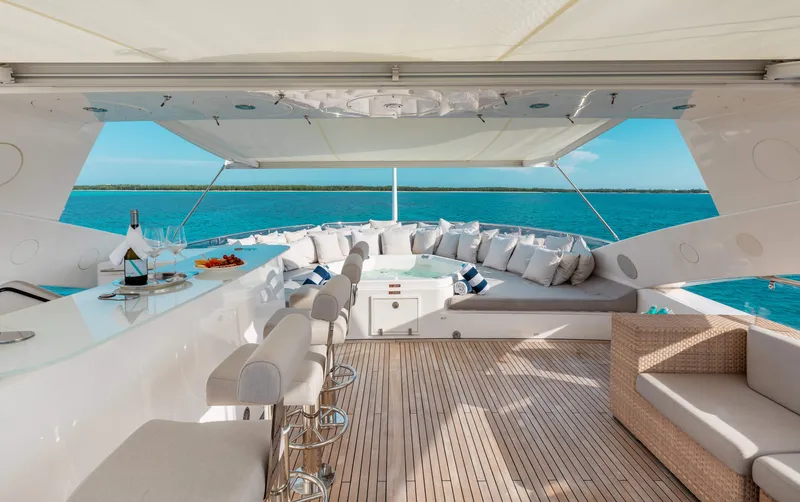Slide: The Image of Luxurious 2009 Sunseeker 121 yacht deck with bar, seating, and ocean view. - 5