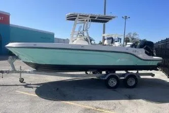 The Image of 2023 Trophy T22 boat on trailer, parked outdoors under clear blue sky. - 1