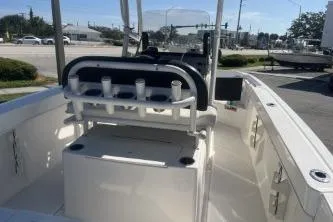 Slide: The Image of 2023 Trophy T22 boat interior with seating and rod holders, parked outdoors. - 10