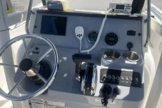 Slide: The Image of 2023 Trophy T22 boat dashboard with steering wheel, controls, and navigation equipment. - 5