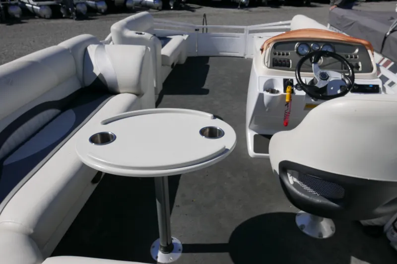 Slide: The Image of Interior of 2010 JC Neptoon 21TT pontoon boat with seating and steering console. - 10