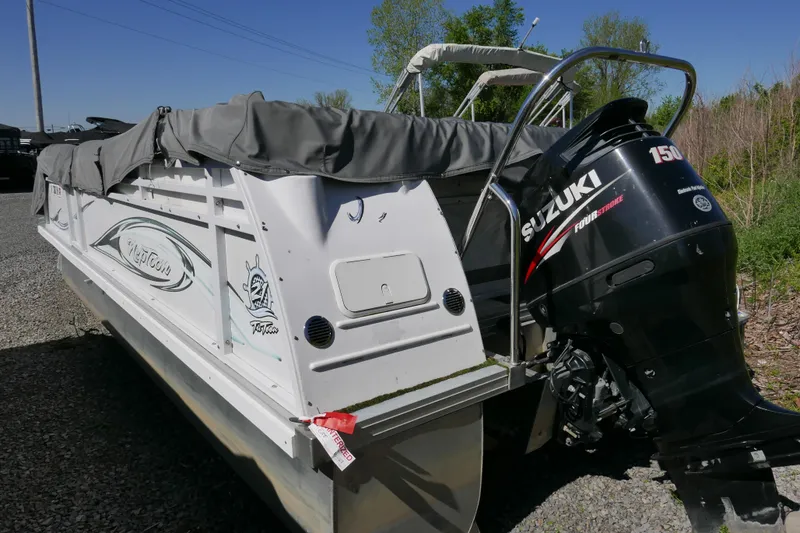 Slide: The Image of 2010 JC Neptoon 21TT pontoon boat with Suzuki 150 outboard motor, parked outdoors. - 15