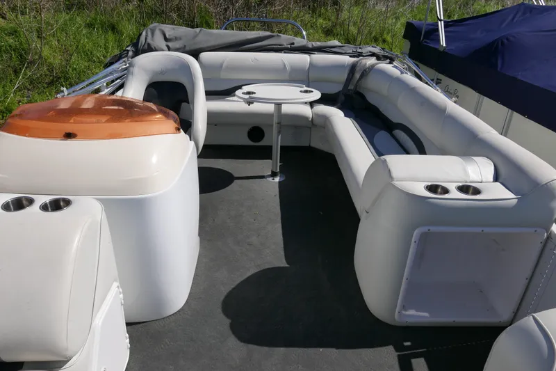 Slide: The Image of 2010 JC Neptoon 21TT pontoon boat interior with seating and table. - 6