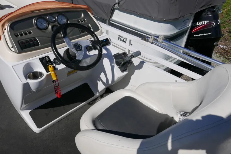 Slide: The Image of 2010 JC Neptoon 21TT boat cockpit with steering wheel and controls. - 7