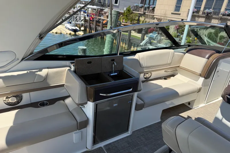 Slide: The Image of 2015 Formula 330 Crossover Bowrider interior with seating and mini bar setup. - 15
