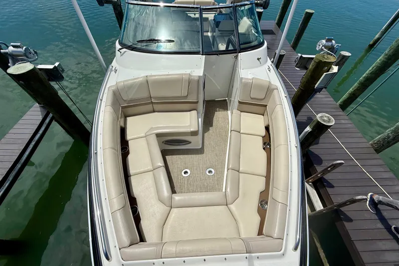 Slide: The Image of 2015 Formula 330 Crossover Bowrider docked, featuring spacious seating and elegant design. - 19