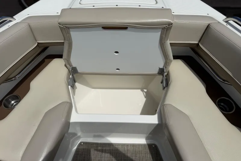 Slide: The Image of 2015 Formula 330 Crossover Bowrider interior storage compartment with beige seating. - 21
