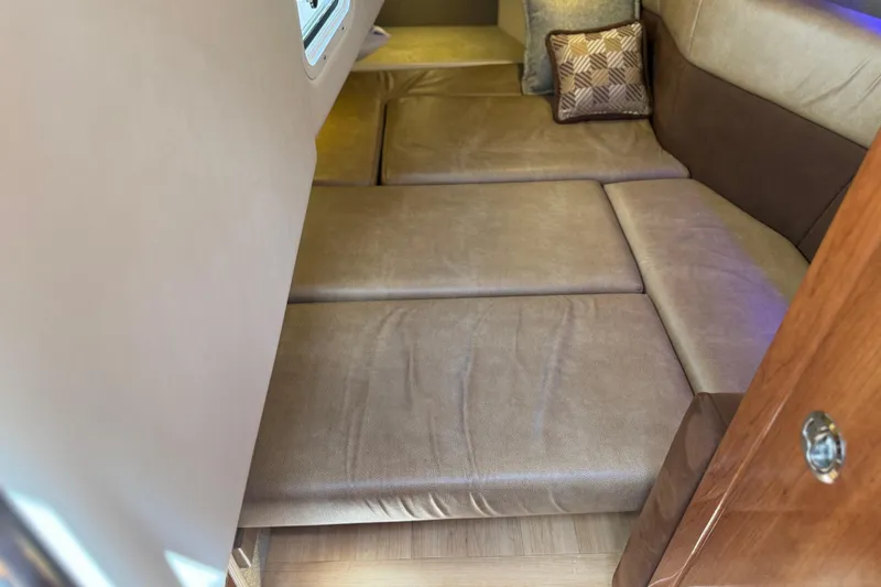 Slide: The Image of Interior cabin of 2015 Formula 330 Crossover Bowrider with beige seating and cushion. - 25