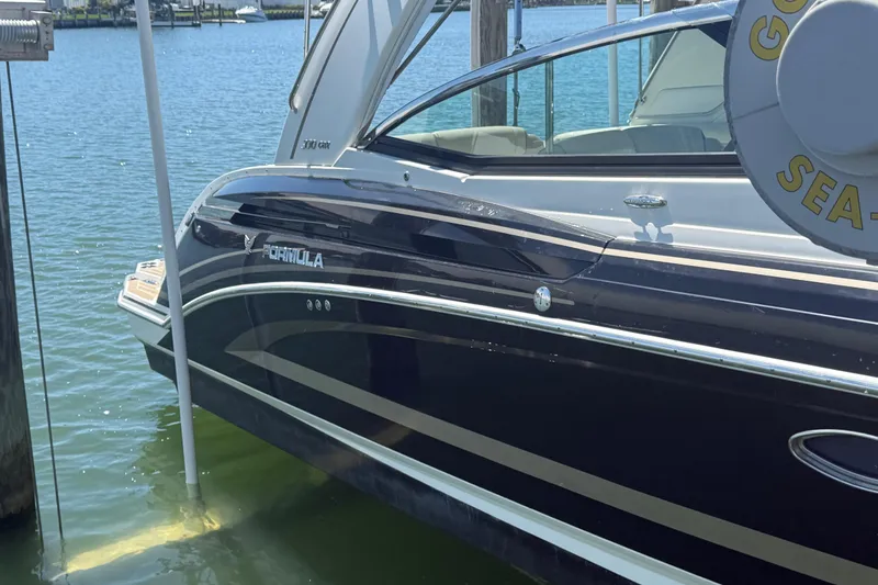Slide: The Image of 2015 Formula 330 Crossover Bowrider docked on calm water. - 33
