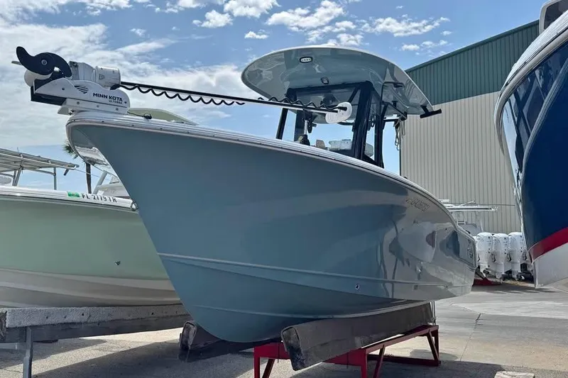 The Image of 2023 Sea Hunt Ultra 239 SE boat on display under a clear sky. - 1
