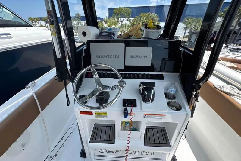 Slide: The Image of 2023 Sea Hunt Ultra 239 SE boat dashboard with Garmin navigation system and steering wheel. - 17