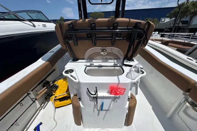 Slide: The Image of 2023 Sea Hunt Ultra 239 SE boat interior with fishing rod holders and seating. - 19