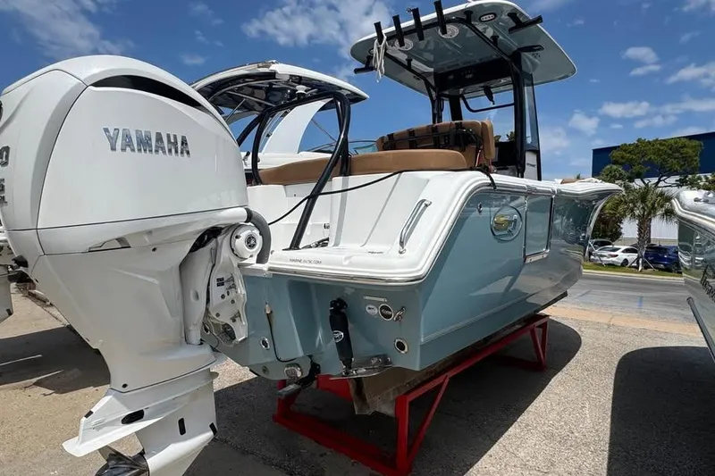 Slide: The Image of 2023 Sea Hunt Ultra 239 SE boat with Yamaha engine, displayed outdoors under blue sky. - 4