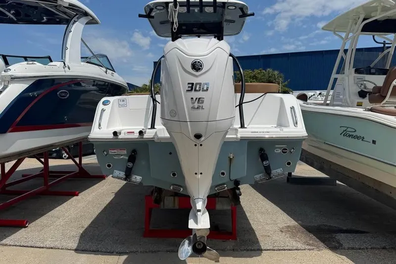 Slide: The Image of 2023 Sea Hunt Ultra 239 SE boat with 300 V6 engine displayed outdoors. - 5