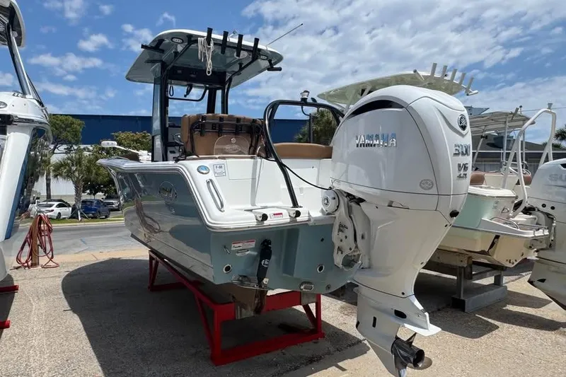 Slide: The Image of 2023 Sea Hunt Ultra 239 SE boat with Yamaha engine on display under blue sky. - 6